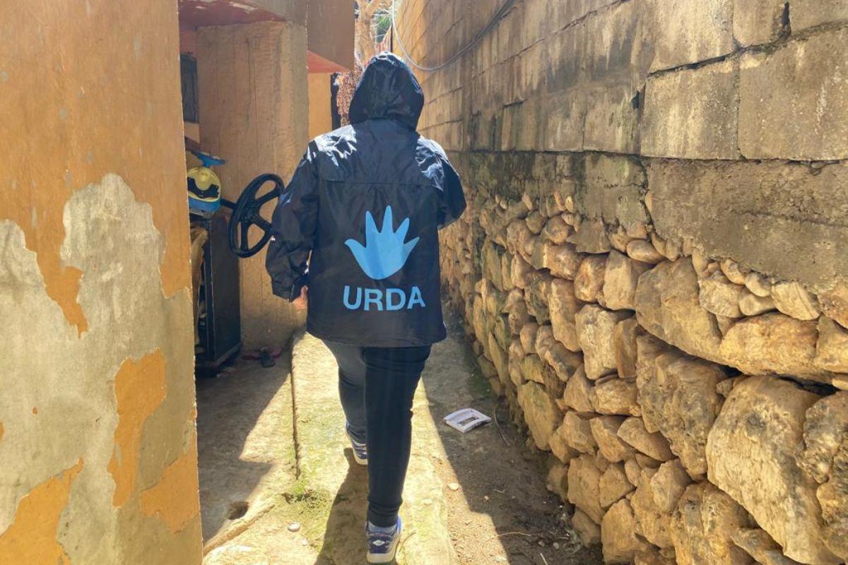 URDA worker walking through an alley in Lebanon